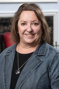 a portrait photo of Sabrina Cave smiling at the camera